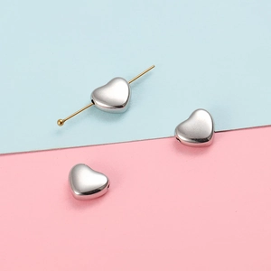 Polished heart-shaped stainless steel beads with pass-through holes for jewelry making
