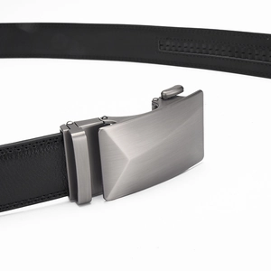 Macro detail of men's leather belt with brushed silver alloy automatic buckle