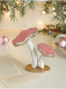 Detail view of pink velvet mushroom ornament with gold glitter sequins and round base