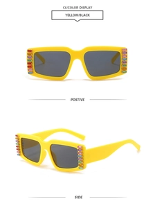Close-up of yellow rectangular sunglasses with colorful rhinestones on frame side