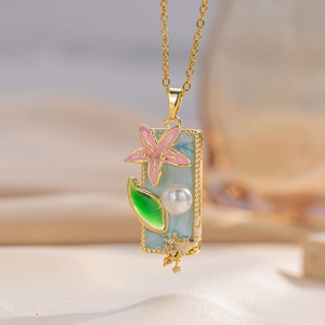 Enameled flower pendant necklace with pink petals, green leaves and a pearl in gold finish