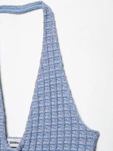 Close-up of light blue waffle texture fabric on a slimming halter neck knit dress