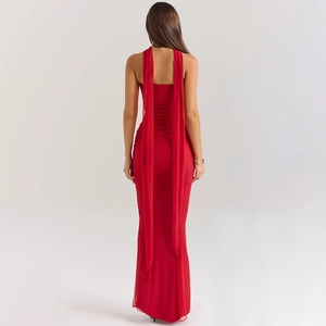 Detail view of a slim red backless dress featuring elegant long streamers and a sleek fit