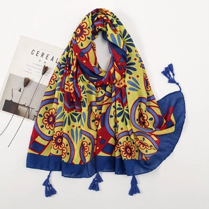 Ethnic printed linen scarf with yellow base, colorful floral patterns and blue tassels