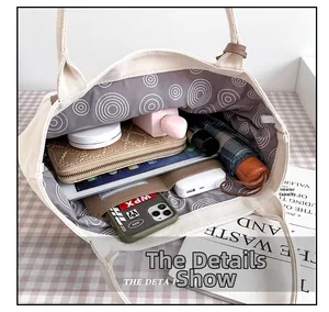 Internal capacity of the canvas tote bag showing tablet, wallet, umbrella, and essentials
