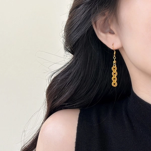 Elegant Chinese style round coin tassel earrings in gold plating on a female model