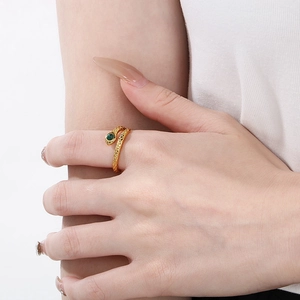Macro shot of gold snake ring featuring green malachite stone inlay and textured scales