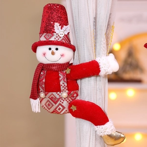 Detail of a Christmas snowman curtain tieback with red sequins and soft plush texture