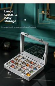 Macro shot of 24-grid gray velvet jewelry box with glass lid and silver metal buckles