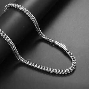Macro shot of 6mm silver stainless steel woven chain with spring buckle closure