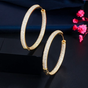 Detailed close-up of 18K gold plated hoop earrings paved with sparkling zircon stones