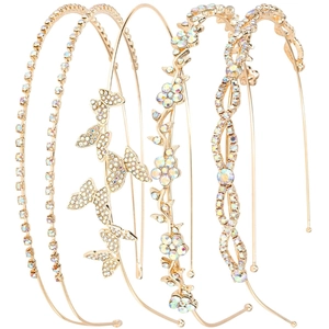 Detail view of five golden bridal headbands with sparkling rhinestones in diverse patterns