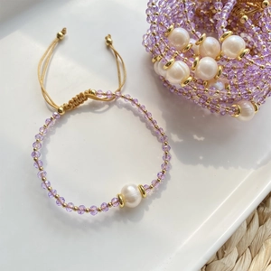 Bohemian handmade bracelet featuring purple crystals and natural freshwater pearls