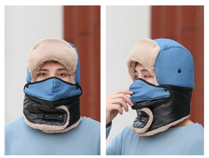 Detail view of winter bomber hat with blue fabric, faux fur lining and integrated face mask
