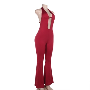 Detail view of red V-neck halter jumpsuit featuring slim fit and flared leg design