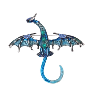 Detailed macro view of flying dragon brooch with blue enamel and sparkling rhinestones