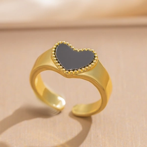 Elegant adjustable gold brass ring with a black heart center and beaded edge detail