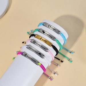 Custom stainless steel braided bracelets for children on a white jewelry display stand