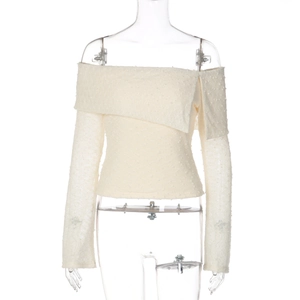 Detail of off-white off-shoulder knit top with unique 3D granular textured fabric