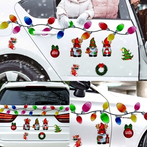 Macro detail of reflective Christmas gnome and bulb magnetic decals on a white car
