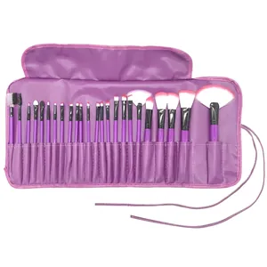 Detailed view of 24 professional purple makeup brushes with a matching leather roll-up bag
