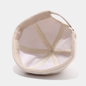 Beige cotton docker cap with six-panel stitching and adjustable metal buckle strap