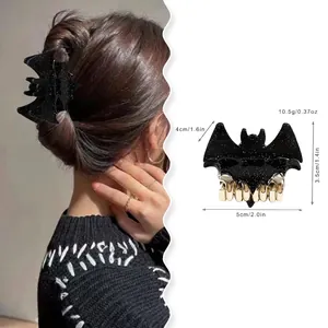 Glittery black bat hair claw clip for Halloween with gold metal teeth for hair styling