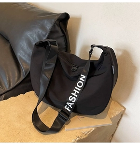 Detail of waterproof Oxford cloth dumpling bag showing adjustable wide logo strap