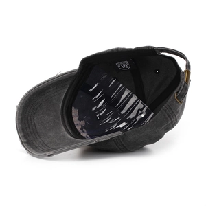 Detailed view of the washed cotton baseball cap with distressed edges and metal buckle