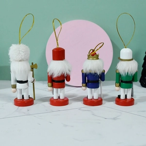 Set of 4 festive 10cm wooden Nutcracker soldier ornaments in red, blue, green, and white