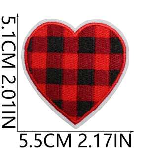 Macro detail of heart-shaped red buffalo plaid embroidery patch with dimensions