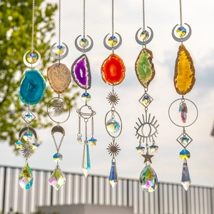Macro detail of agate suncatchers with crystal prisms and gold moon star metal pendants