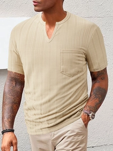 Detail of men's beige waffle knit Henley shirt with a V-neck and chest pocket