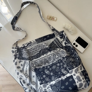Detail of blue and white paisley patchwork cotton fabric on a large capacity tote bag