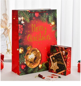 Detail of red Christmas gift bags with gold foil patterns and matching cards