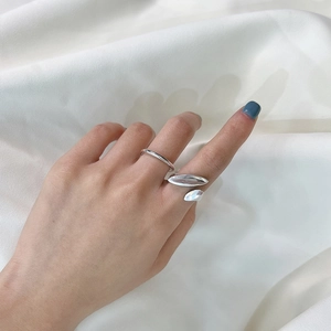 Minimalist S925 sterling silver adjustable rings with high polish finish on white silk fabric
