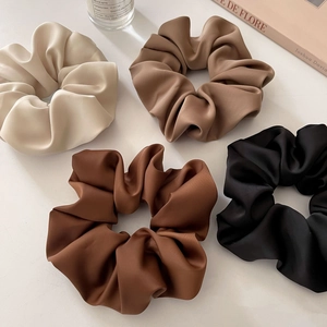 Four-pack matte satin oversized scrunchies in earth tones like beige, taupe and black