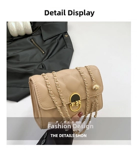 Detail view of beige quilted faux leather bag with gold metal clasp and ball chain strap