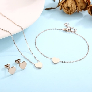Elegant rose gold heart jewelry set including necklace, bracelet, and stud earrings