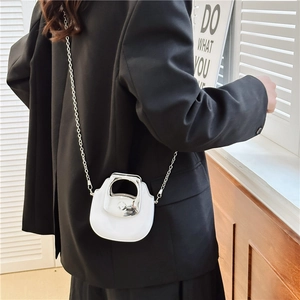 Mini white saddle bag with silver metal handle and chain strap for stylish women