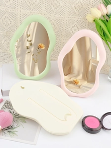 Detail view of cloud-shaped mirrors showing back foldable stand and wall mounting hole