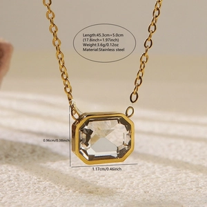 Macro view of gold stainless steel necklace with octagonal faceted clear gemstone pendant
