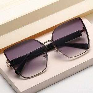 Oversized cat-eye sunglasses with purple gradient lenses and gold mesh metal details