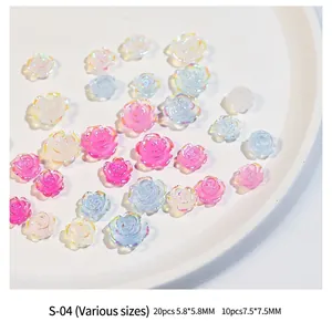 Macro view of aurora camellia nail charms in various sizes and iridescent colors