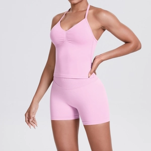 Detailed view of pink halter yoga set with high waist shorts and ruched front top