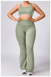 Front view of sage green plus-size yoga set with sports bra and flared leggings