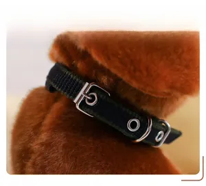 Detail of soft plush puppy collar with polished silver metal buckle and fine stitching