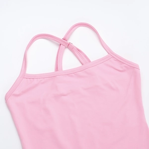Close-up of pink sports top featuring cross-back straps and fine knit fabric texture