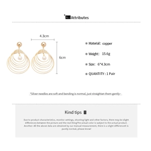 Detail view of multi-layer round pearl drop earrings with size 6x4.3cm and copper material