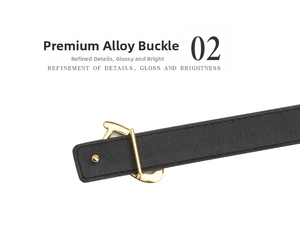 Close-up of heart-shaped gold alloy buckle on a black minimalist leather belt for women